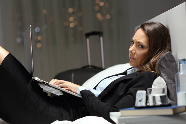 istock Unhappy worker working late hours in an hotel room 1010555700