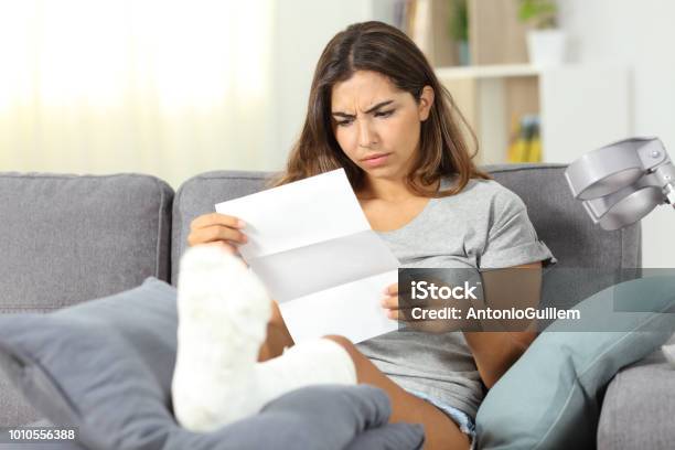 Worried Disabled Woman Reading A Letter Stock Photo - Download Image Now - Financial Bill, Healthcare And Medicine, Patient