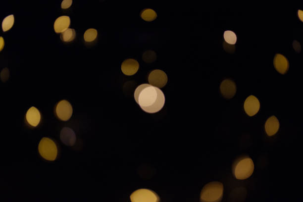 istock Gold bokeh circles on a dark background, abstraction, background 1010556466