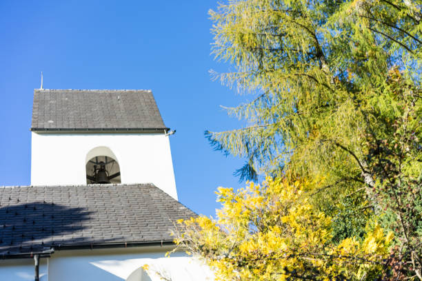istock white church and green tree with blue sky 1010559438