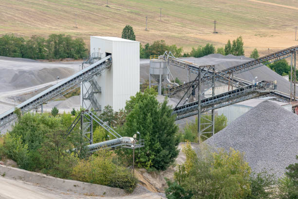 istock Mining quarry with machinery. Belt conveyors and mining equipment in a quarry. Stone quarry with silos, conveyor belts and piles of stones. Quarrying of stones for construction works. 1010564122