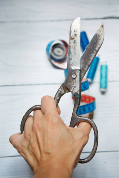 istock The scissors tool in the hand of man. 1010572652