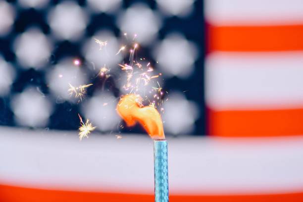 istock Close-Up Of Illuminated Firework Against American Flag 1010580216