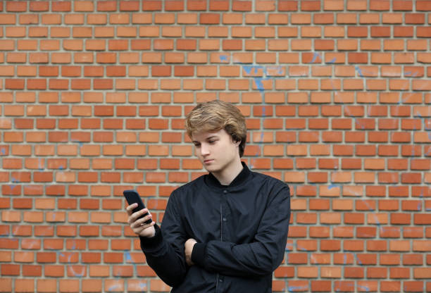 istock Teenage boy typing text message.Using smart phone. 1010586380