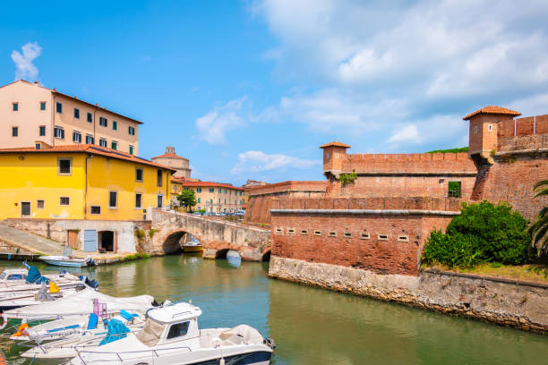 New fortress on the canal in Livorno, Tuscany, Italy Close up of new fort or Fortezza Nuova with boats and colorful houses near the fortress and canal of Livorno, Tuscany, Italy livorno stock pictures, royalty-free photos & images