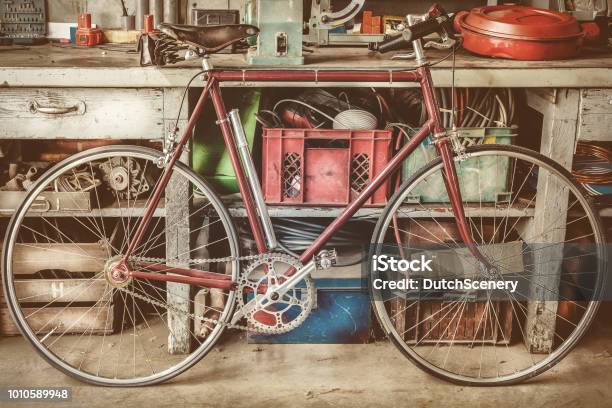 Vintage Racing Bycicle In Front Of An Old Work Bench With Tools Stock Photo - Download Image Now