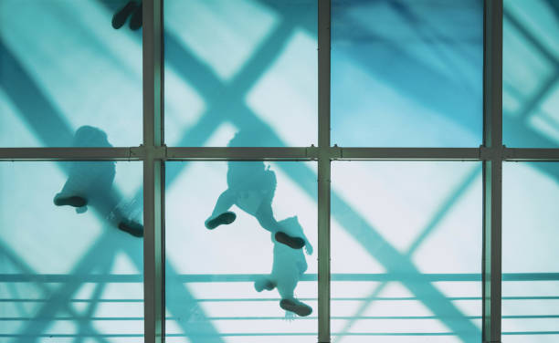 istock people on pedestrian glass bridge 1010597220
