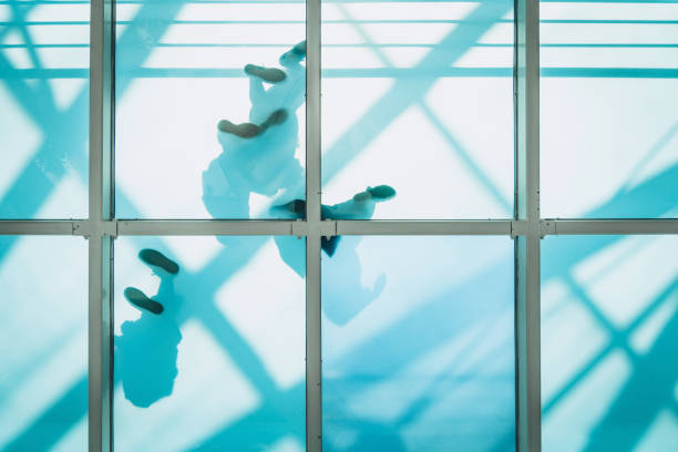 istock people on pedestrian glass bridge 1010597364