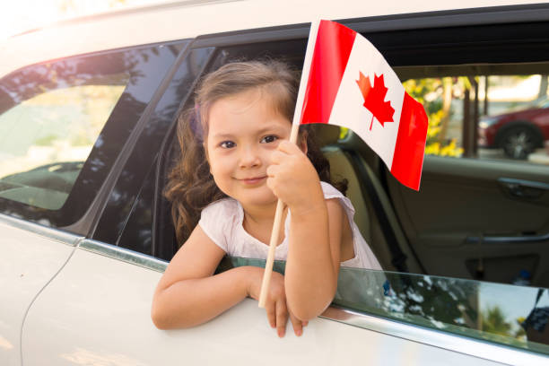 istock Girl Holding Canadian Flag 1010597822