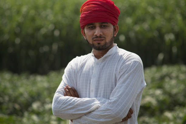 Farmer with arms crossed in field