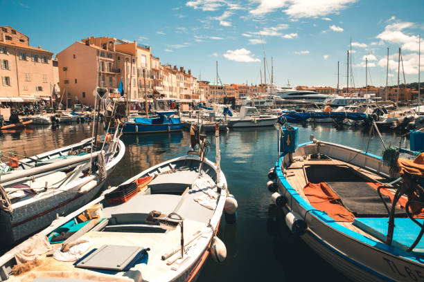 Small boats anchored at Quai Jean Jaures fronting the harbor at St Tropez, Provence, France.