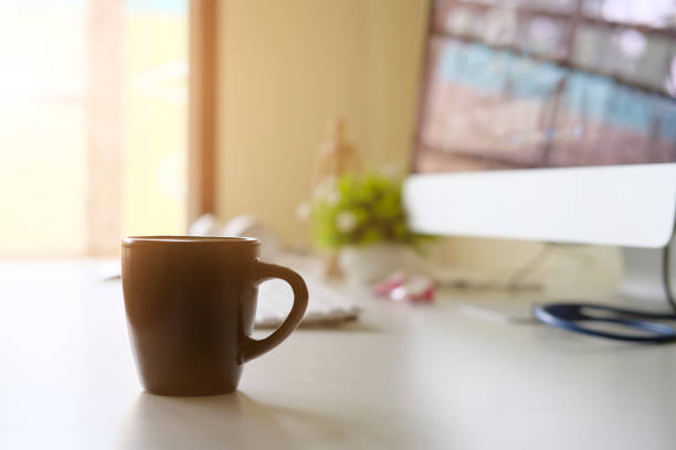 istock Mug of coffee on office workplace with morning coffee concept. 1010606294