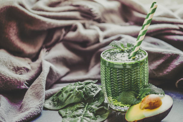 Green Smoothie and with Vegetables, Fruits, and Chlorella Green smoothie and some ingredients such as vegetables, fruits and Chlorella powder shot on a slate with a sustainable straw – moody photography chlorella stock pictures, royalty-free photos & images