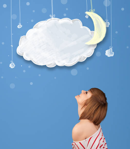 istock Young girl looking at cartoon night clouds with moon 1010610984