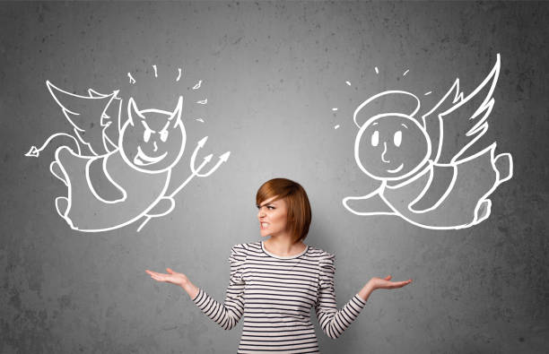 istock Woman standing between the angel and the devil 1010613316