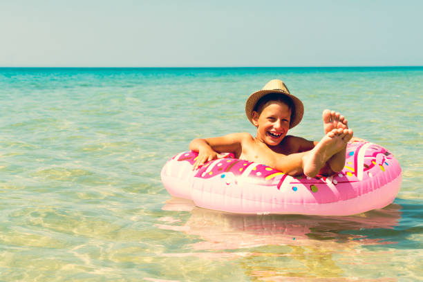istock Child with inflatable ring in sea, toned 1010615056