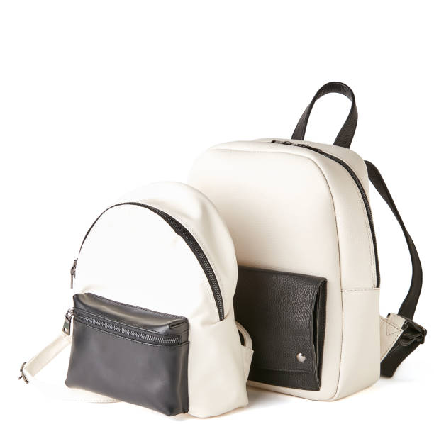 istock Womans elegant leather white and black backpacks. Studio shot, white background 1010615146