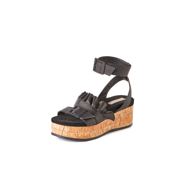 istock Women's black flat platform sandal with decorated top. Studio shot, white background 1010618736