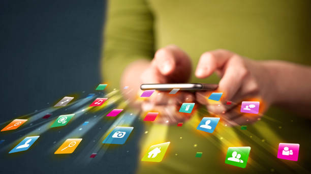 istock Man holding smartphone with technology application icons 1010624998