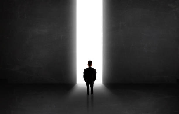 istock Business person looking at wall with light tunnel opening 1010631596