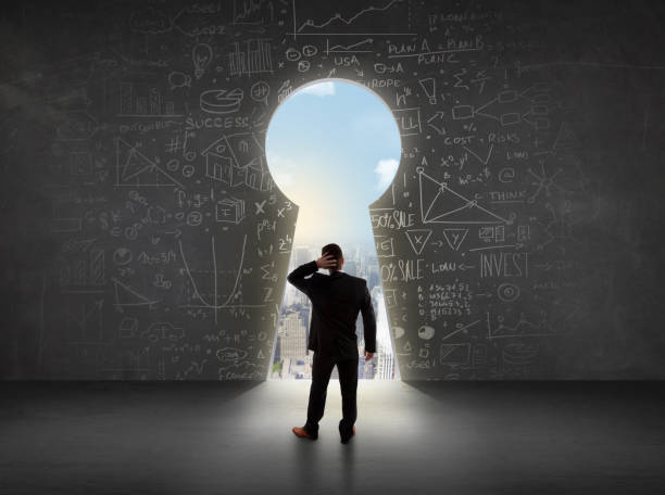 istock Business man looking at keyhole with bright cityscape concept 1010631738