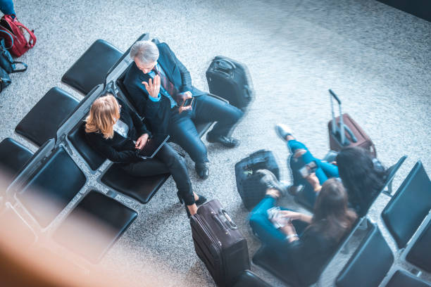 istock Passengers sitting on seats at airport terminal 1010631812