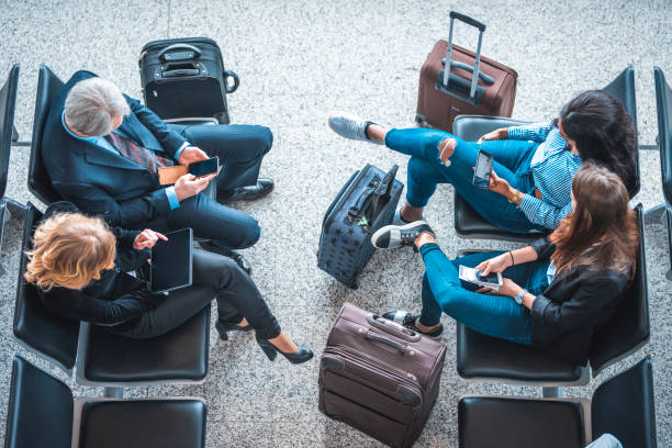 istock Passengers sitting on seats at airport terminal 1010631860