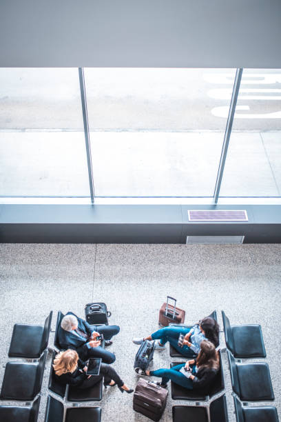 istock Passengers sitting on seats at airport terminal 1010631980