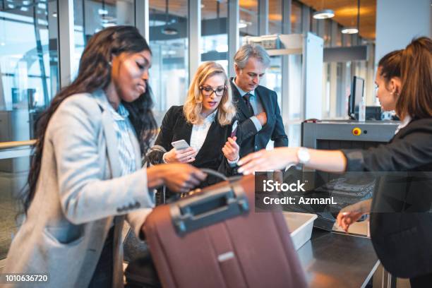 Passengers Standing By Security Scanner At Airport Stock Photo - Download Image Now - Airport, Security, Security Staff
