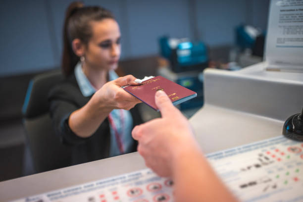 istock Attendant giving passport to passenger 1010636740