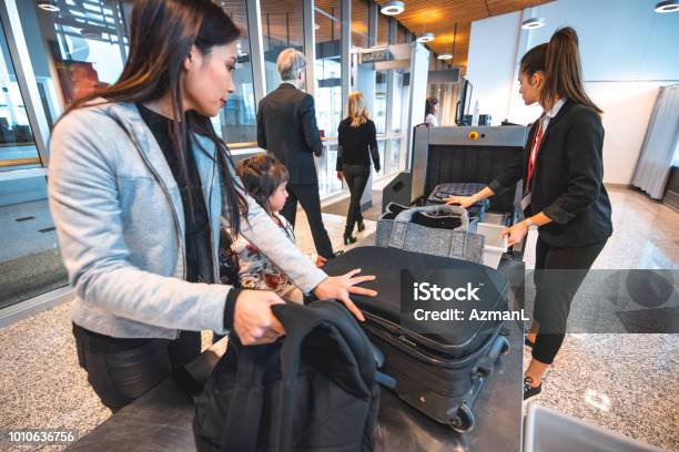 Family With Luggage At Airport Security Check Stock Photo - Download Image Now - Airport, Security, Security System