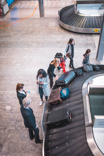 People waiting for baggage at airport terminal