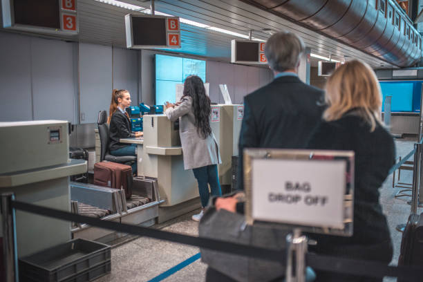 istock Staff with passenger at airport check-in counter 1010637218