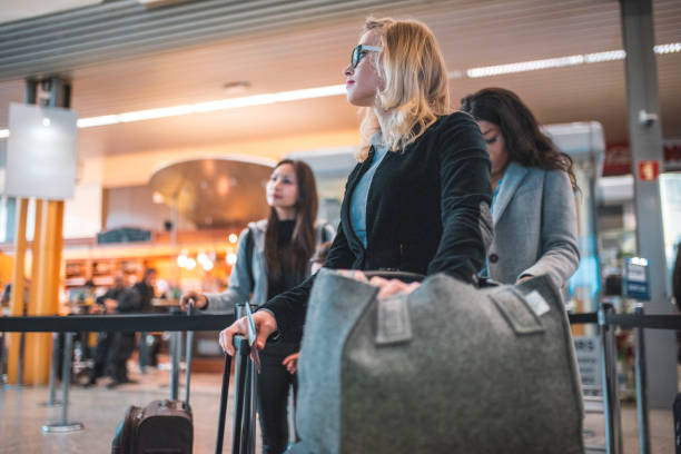 istock Passengers waiting in queue at airport terminal 1010637252