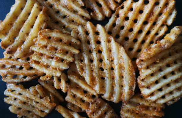 istock Waffle Fries on Black Background 1010638006