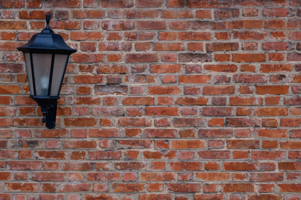 istock Classic outdoor lantern on red brick wall background. Copy space. 1010639288