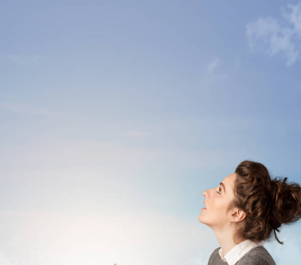 istock Girl looking at the blue sky copyspace 1010641948