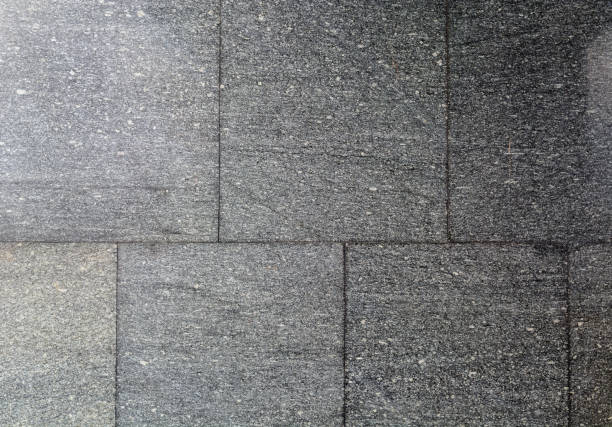 istock Texture of black or dark gray granite. Geometric smooth boundaries. Treated stone. 1010647440