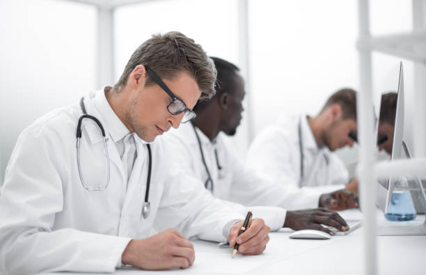 experienced doctor sitting at the laboratory table stock photo