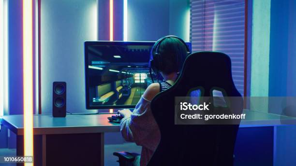 Beautiful Professional Gamer Girl Playing In Firstperson Shooter Online Video Game On Her Personal Computer Casual Beautiful Professional Gamer Girl Playing In Firstperson Shooter Online Video Game On Her Personal Computer Casual