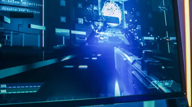 Close-up Shot of the Computer Screen with First-Person Shooter Online Video Game Gameplay in Progress. Stylish High-End Graphics Entertainment.