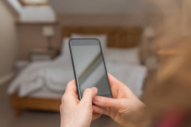 istock Woman is looking at a blank smart phone screen with copy space 1010654736