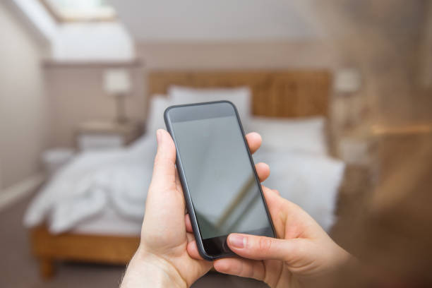 istock Woman is looking at a blank smart phone screen with copy space 1010654764