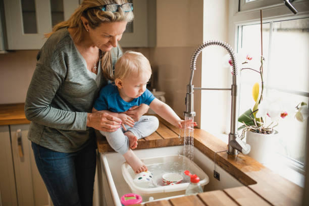 istock Grandmother Helps Grandson Wash His Hands 1010659408