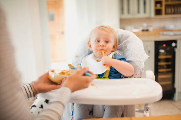 istock Baby Boy Enjoying Some Food 1010659812