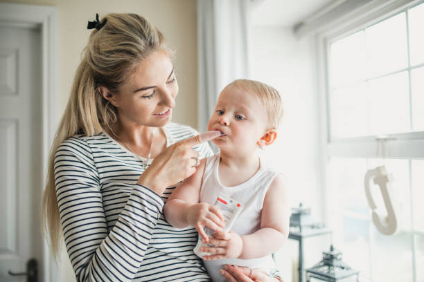 Mother Brushes Her Baby Son's Teeth