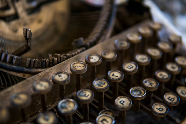 istock Close up view on an old dirty broken antique typewriter machine keys with Cyrillic symbols letters. 1010664624