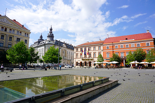 The central square of the city of Ostrava - Masaryk Square. People hang out around the Marian Column, in the background, the building of the Ostrava Museum.