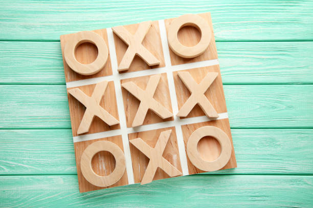 istock Wooden tic tac toe game on mint table 1010675246