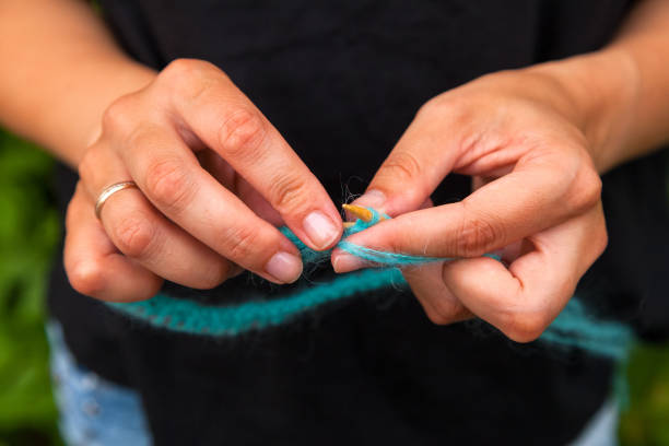 istock A young woman knits 1010675288